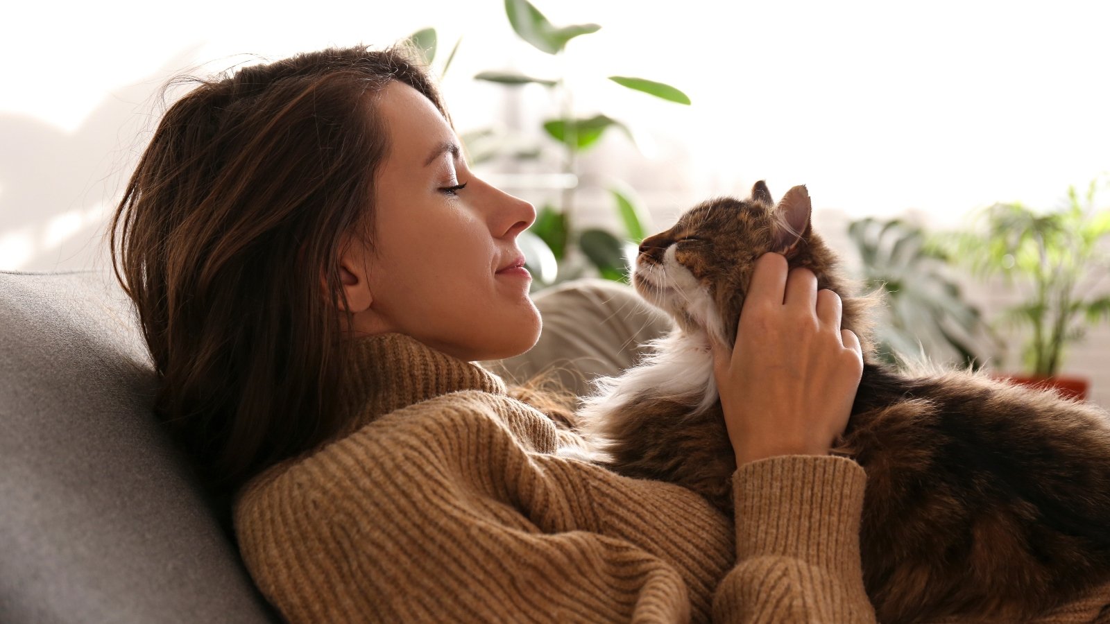 A woman and a cat looking at each other