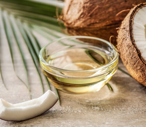 Coconut and its oil on a table