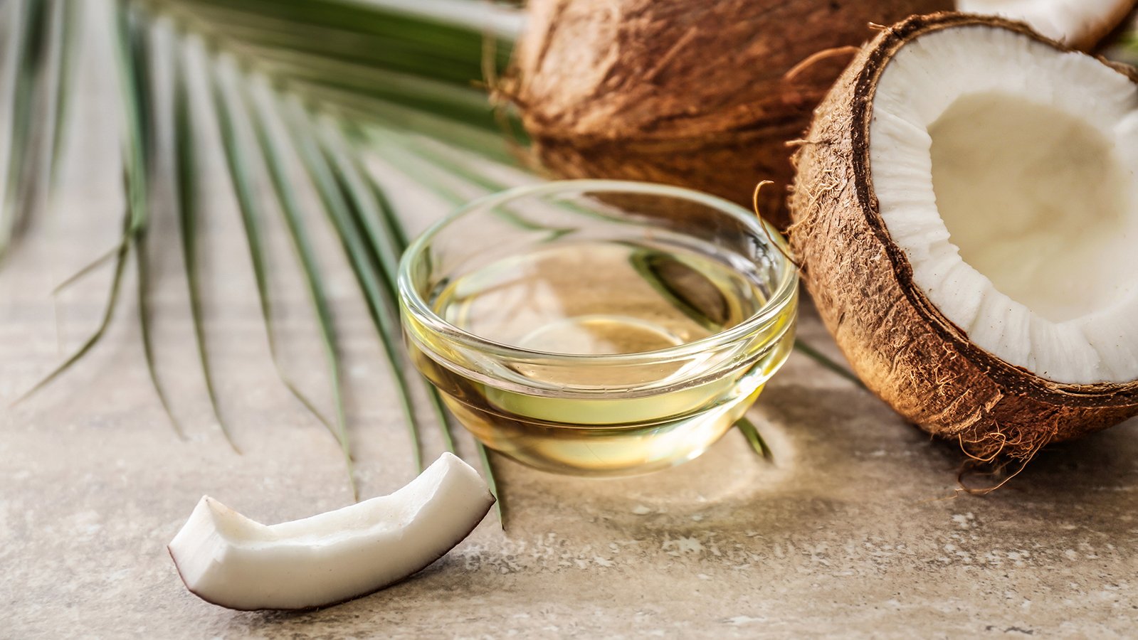 Coconut and its oil on a table