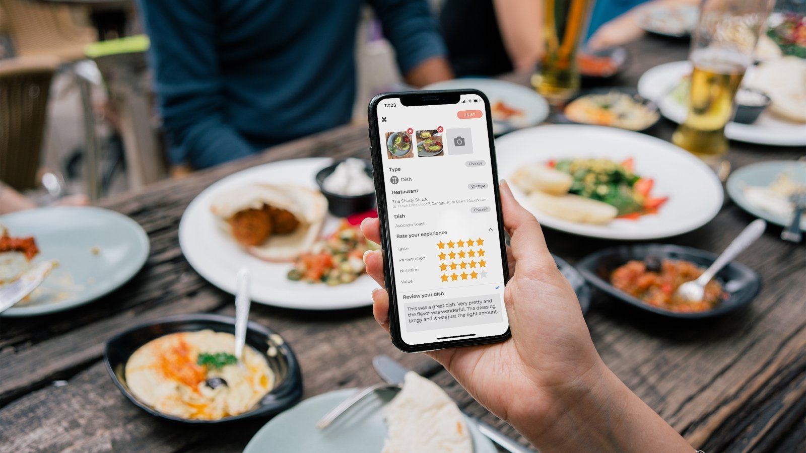 a person holds their phone at a table with the abillion app showing