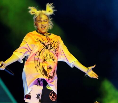 Billie Eilish jumps on stage under green lights