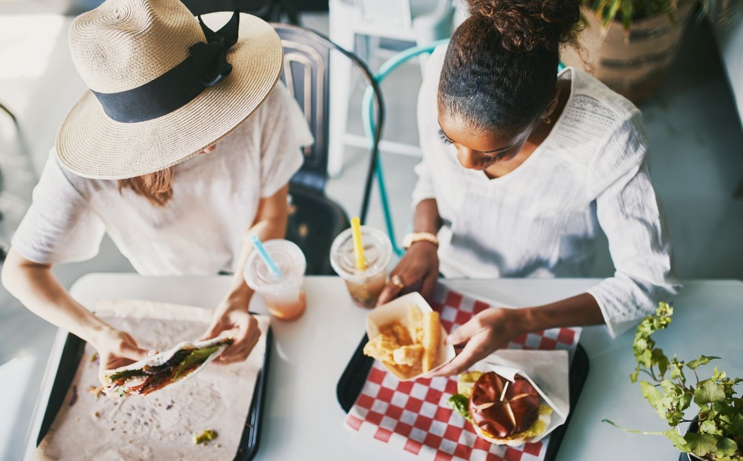 Two friends eating vegan food at a plant-based fast food restaurant