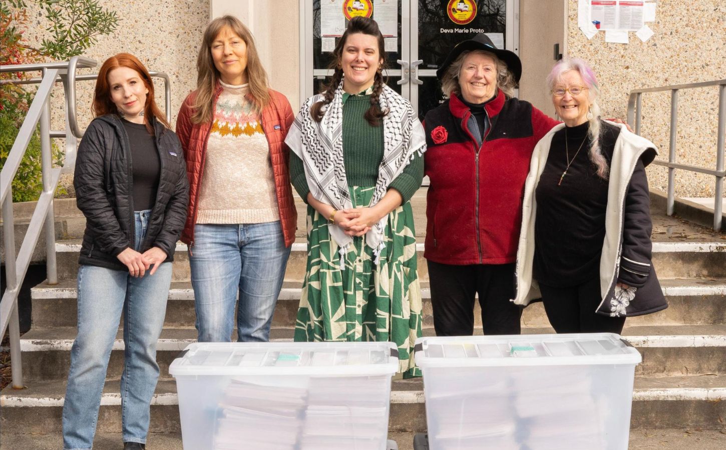 Photo shows five CEFF volunteers standing with large boxes of signatures before handing them in