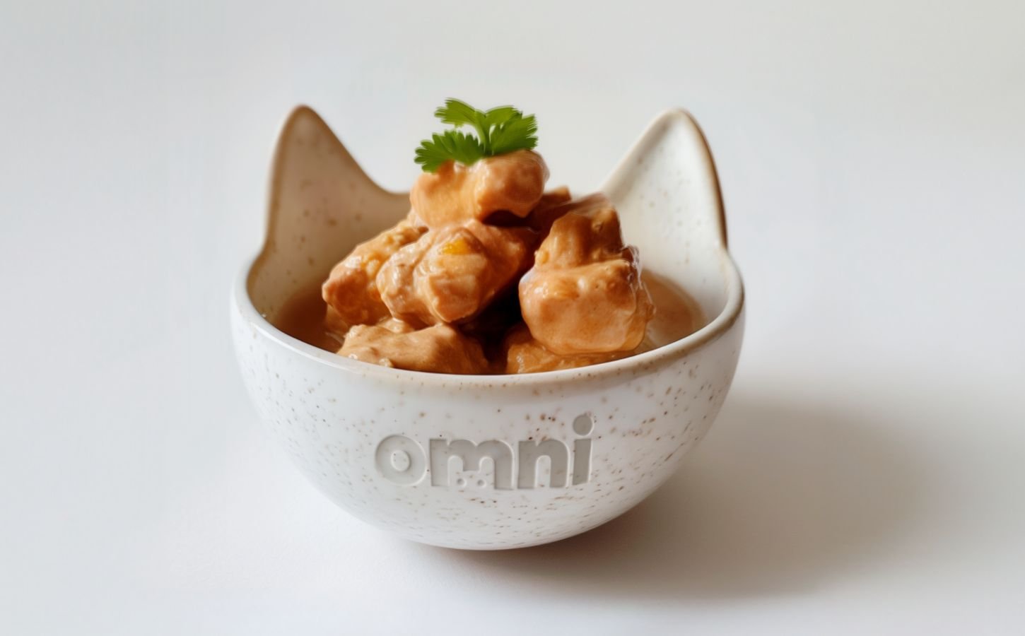 A bowl of cat food made from cultivated chicken in a bowl reading "omni"