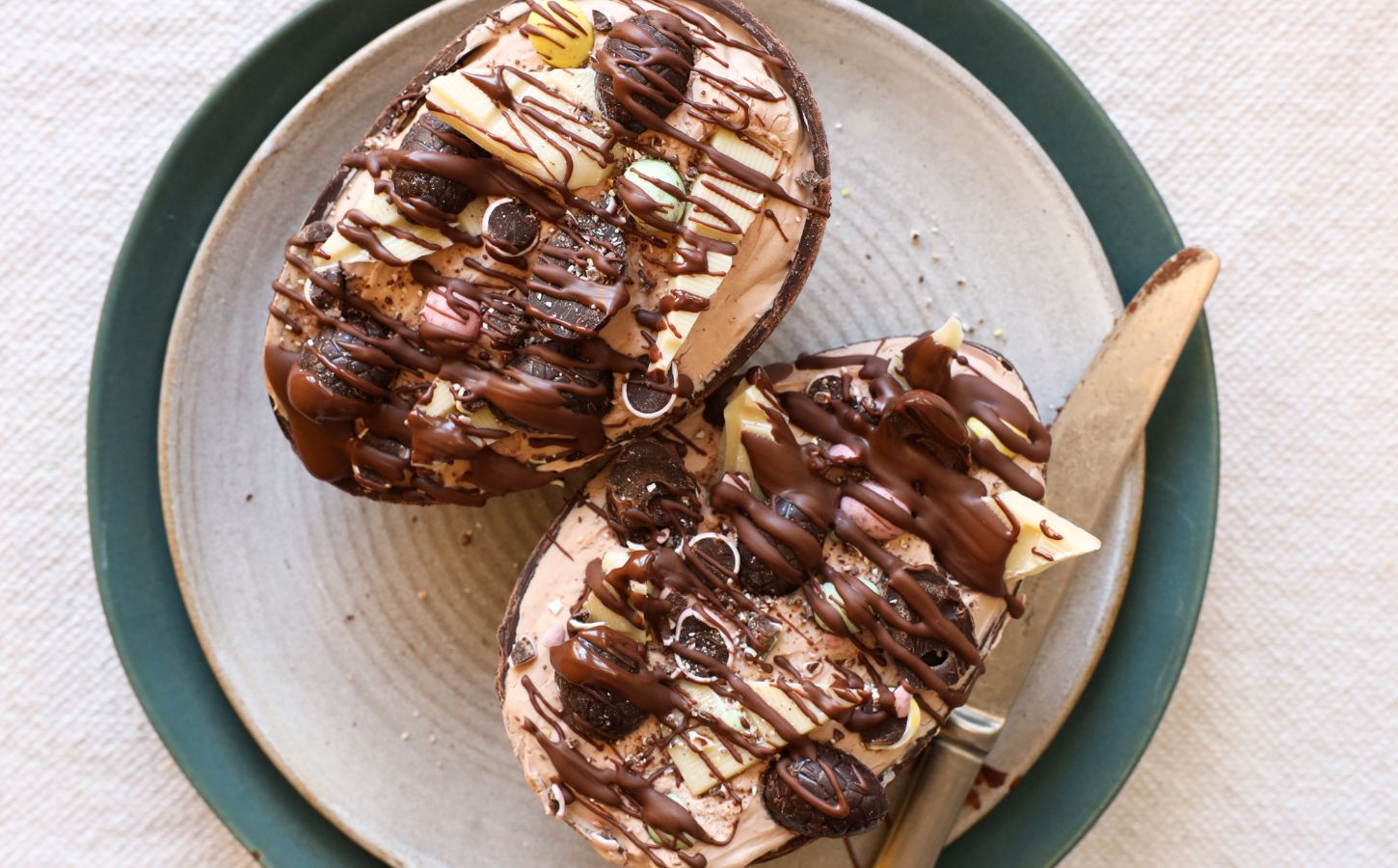 vegan Easter eggs stuffed with plant-based cheesecake mixture and topped with vegan salted caramel and Mini Eggs