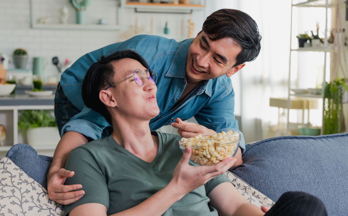 a young gen z couple eating popcorn together