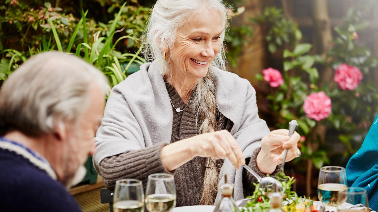 woman serves salad in the garden