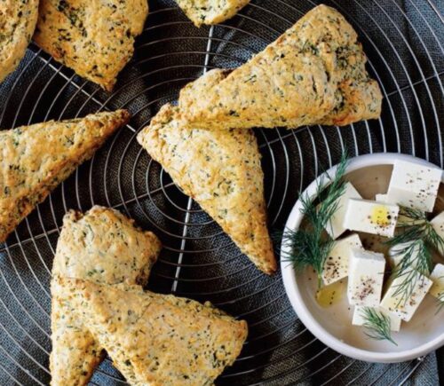 A tray of vegan herb scones with a side of macadamia feta