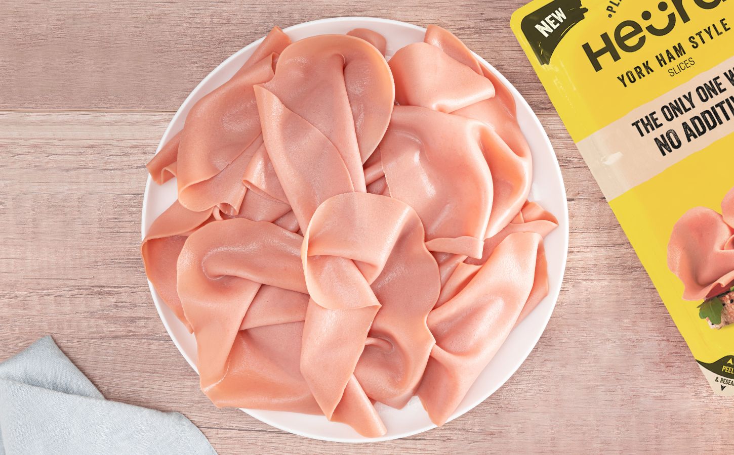 Heura's new cold cut additive-free vegan ham slices on a plate