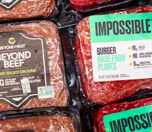 A packet of Beyond Beef beside Impossible Foods' meat