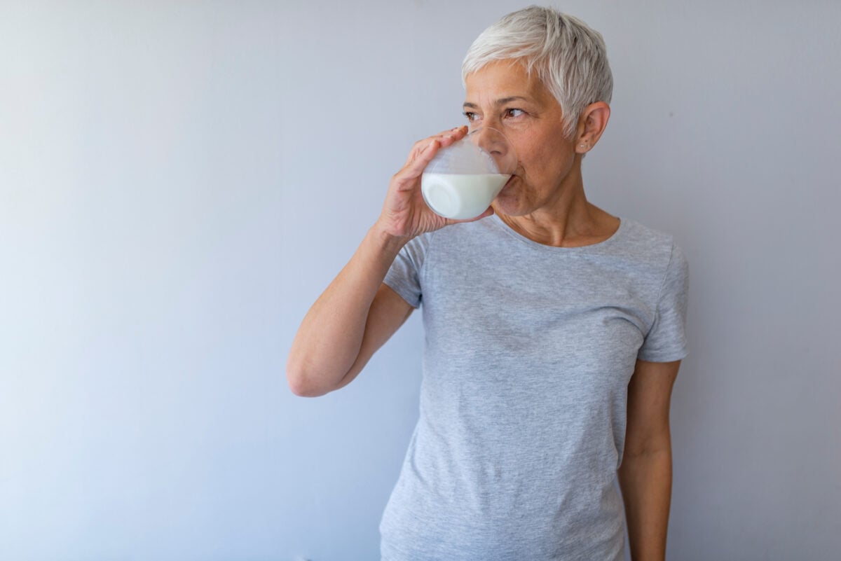 A woman drinking a glass of milk