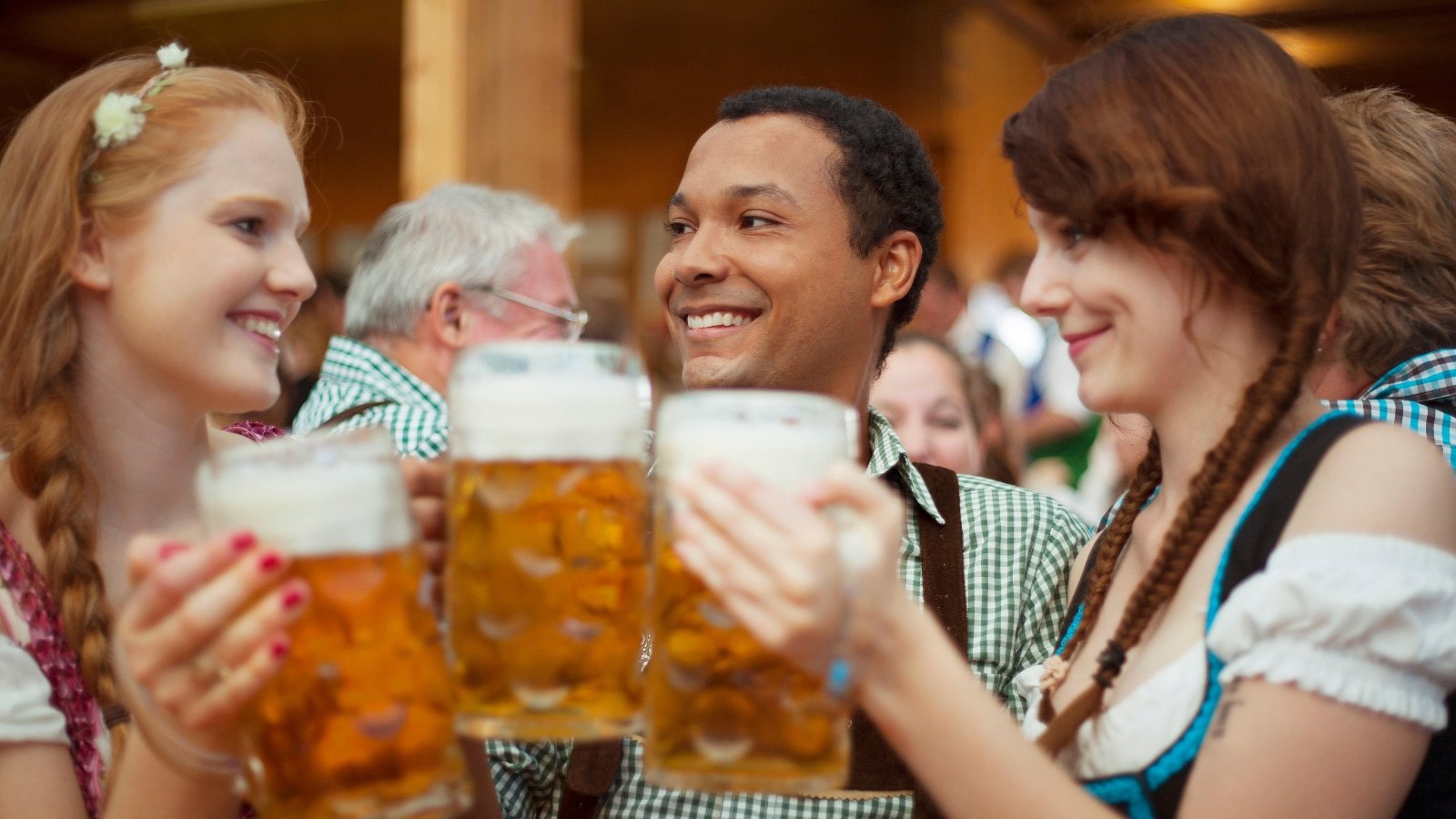 Three friends enjoying beers at Oktoberfest