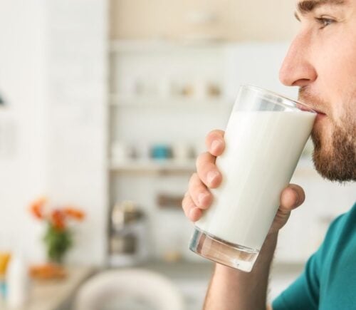 A man drinking raw milk in a kitchen