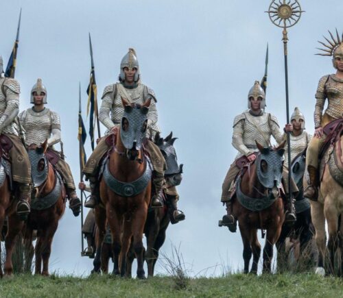 A still of The Rings Of Power, featuring horses heading off to battle