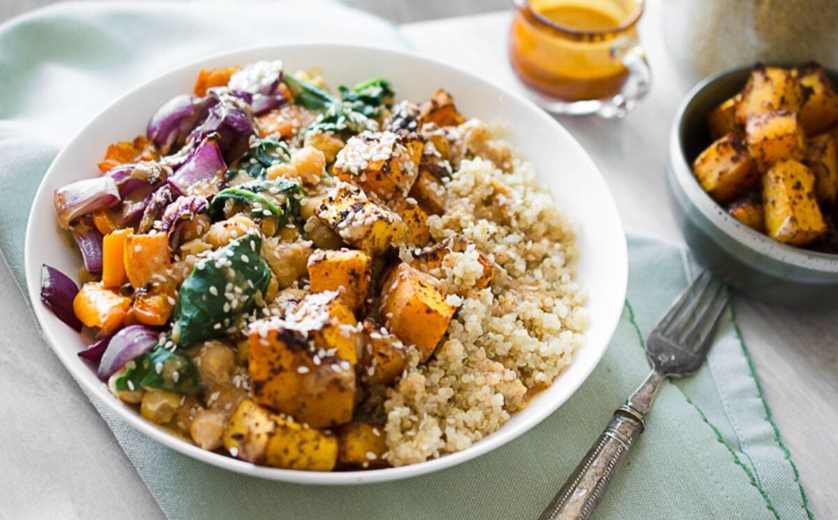 vegan roasted butternut squash and quinoa bowl made with chickpeas spinach and an almond citrus sauce