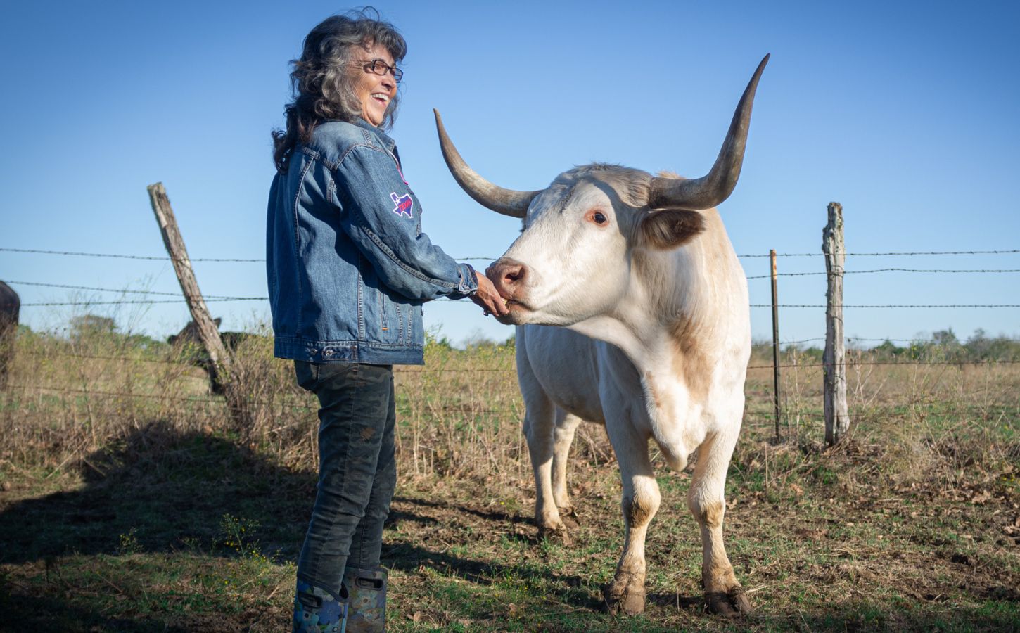 Renee King-Sonnen with a cow at Rowdy Girl vegan animal rescue sanctuary in Texas