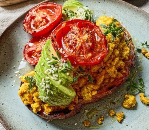 Vegan scrambled tofu served with egg, tomato, and avocado