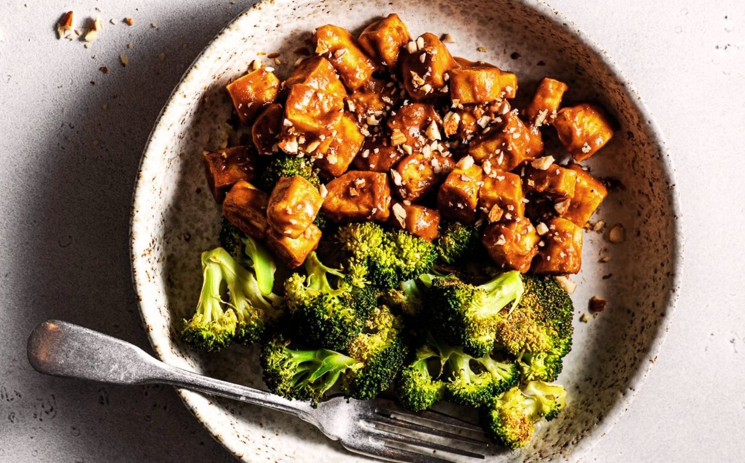 Sheet pan broccoli and tofu covered in a sticky sauce roasted in one pan