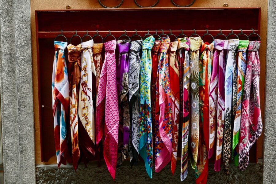 A selection of brightly colored scarves made from silk, a material often considered to be cruel