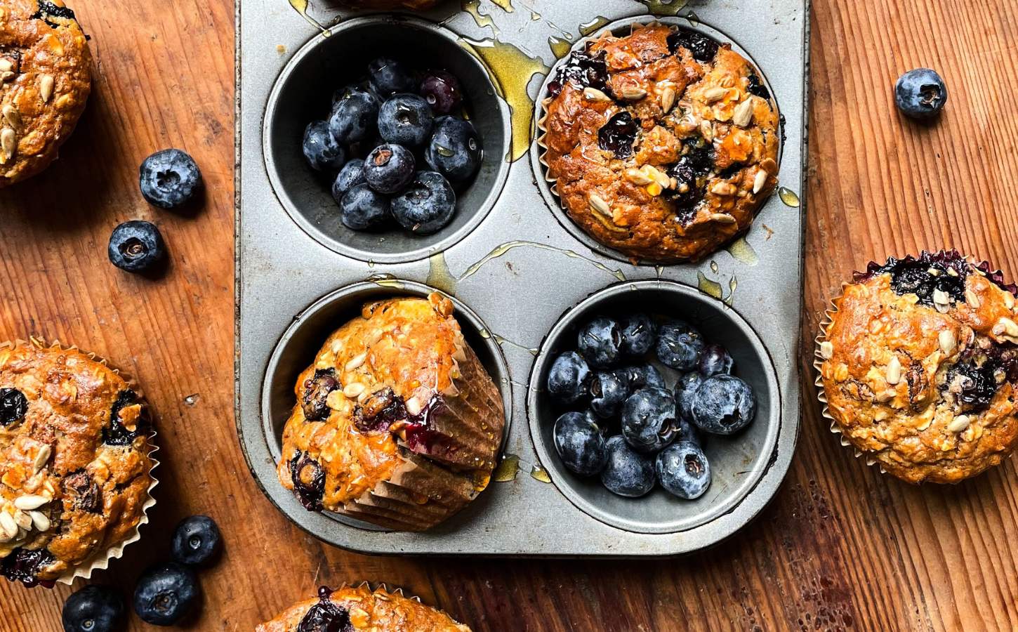 A tray of freshly cooked vegan breakfast muffins with blueberries