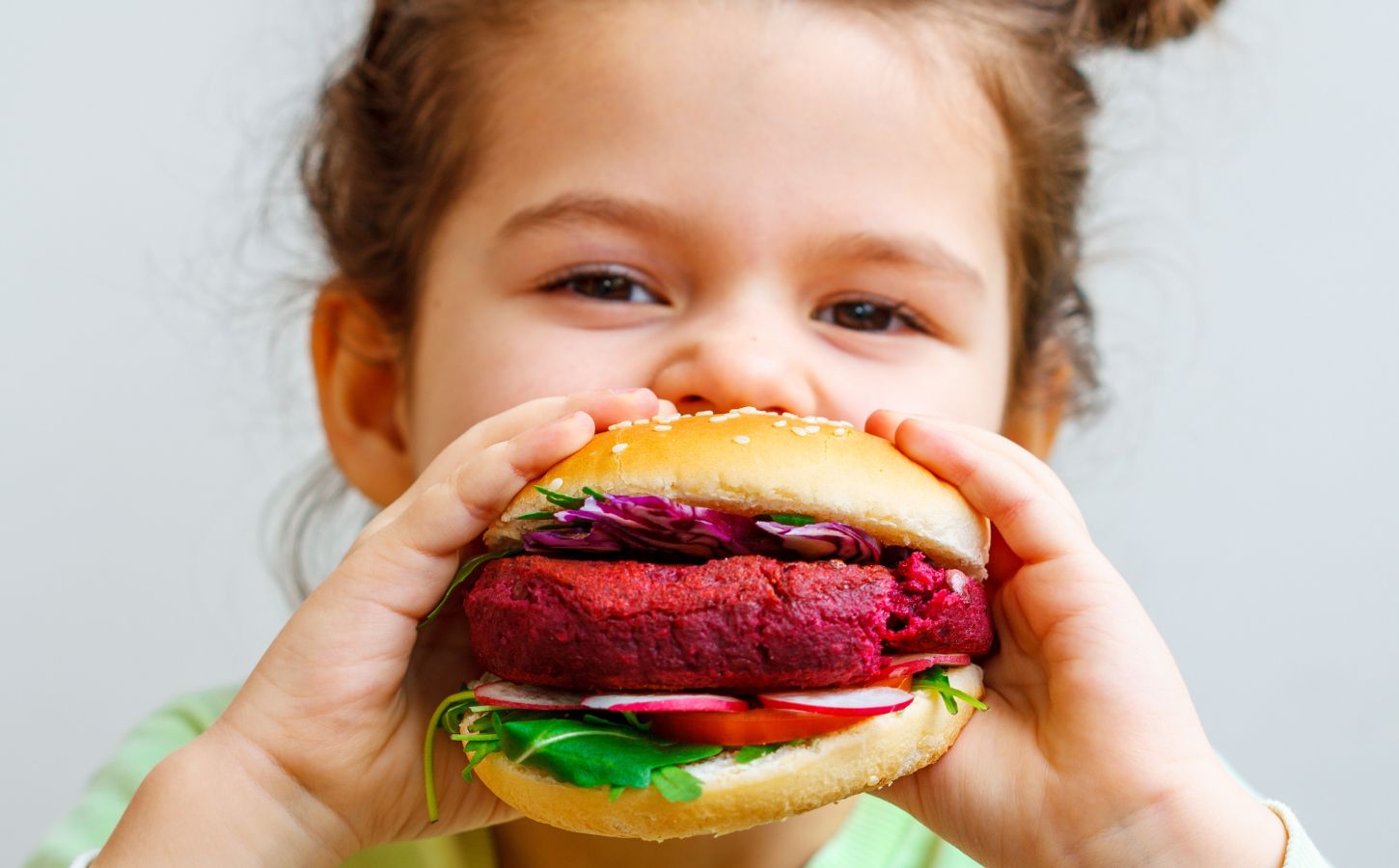 A girl eating a vegan burger