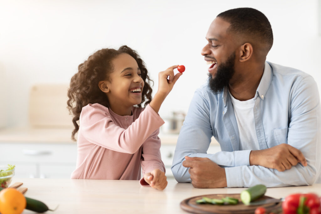 A dad and daughter making healthy vegan food and meals in a kitchen