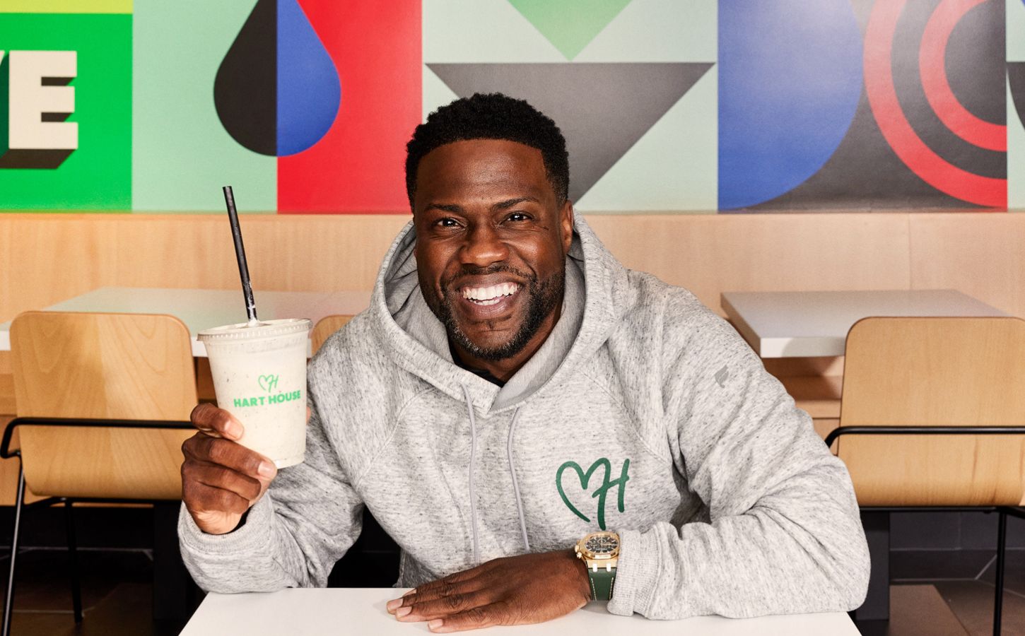 Kevin Hart, founder of vegan fast-food chain Hart House, sitting in the new Hollywood drive-thru location