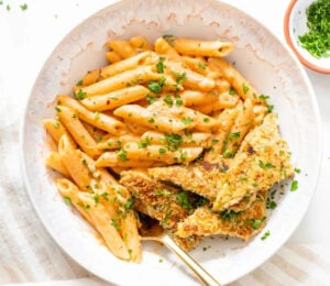 Photo shows a large white bowl of a vegan Cajun-style pasta recipe made with tempeh, a gut-friendly fermented food