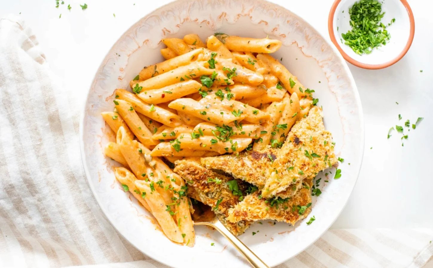 Photo shows a large white bowl of a vegan Cajun-style pasta recipe made with tempeh, a gut-friendly fermented food