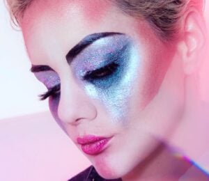 Close up shot of a woman wearing lots of brightly colored eye shadow