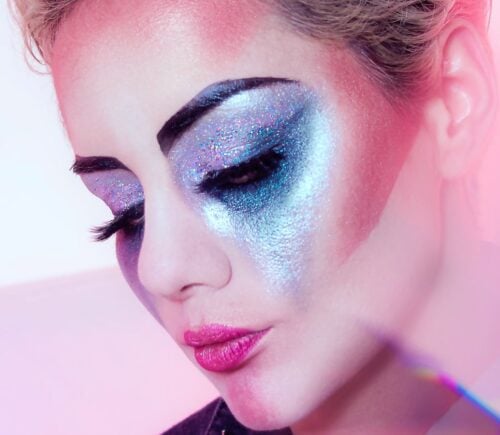 Close up shot of a woman wearing lots of brightly colored eye shadow