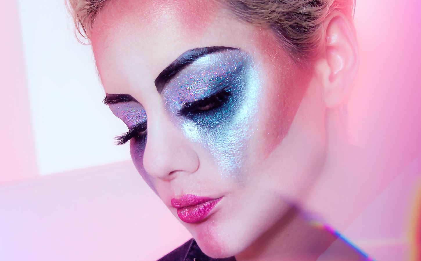 Close up shot of a woman wearing lots of brightly colored eye shadow