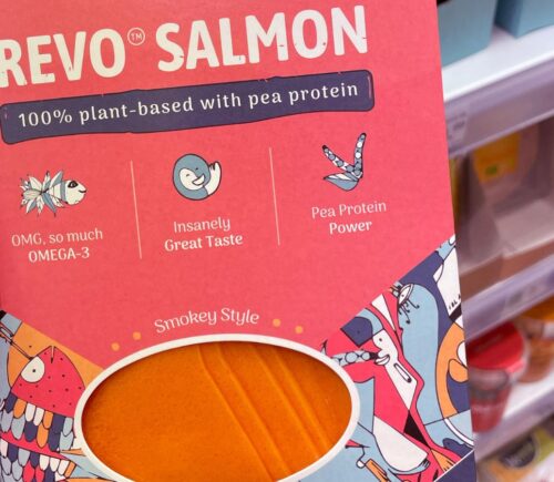 Photo shows someone holding a package of plant-based 'Revo Salmon' in the supermarket.