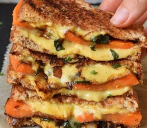 Photo shows a recipe for a vegan grilled sandwich featuring carrots and spinach as well as plant-based cheese