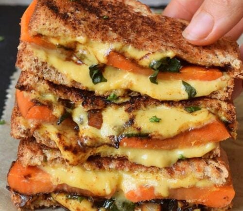 Photo shows a recipe for a vegan grilled sandwich featuring carrots and spinach as well as plant-based cheese