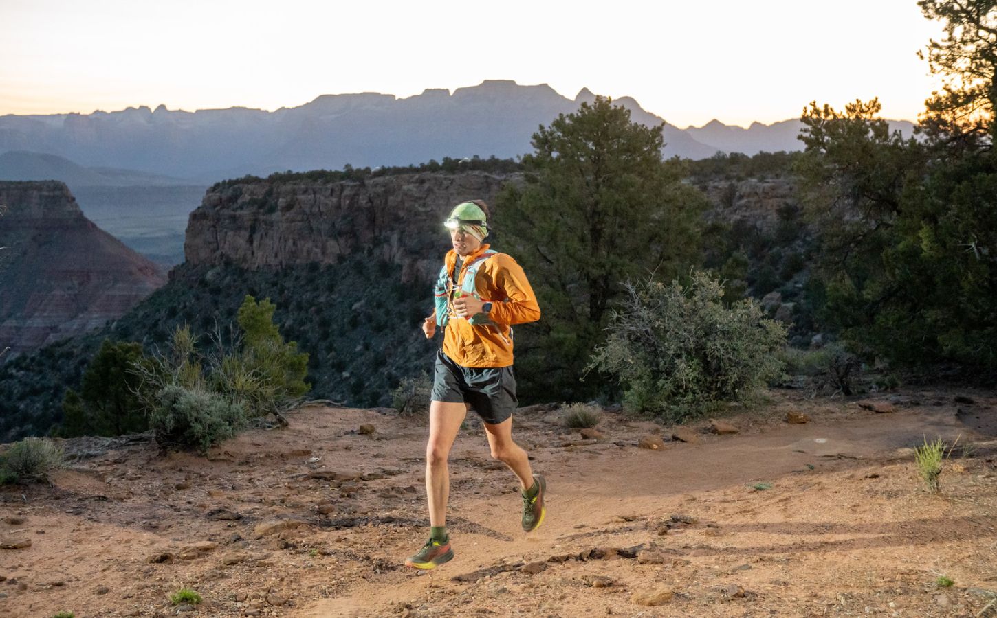 Vegan athlete and runner Austin Meyer running at sunset during the Zion 100km ultra-marathon