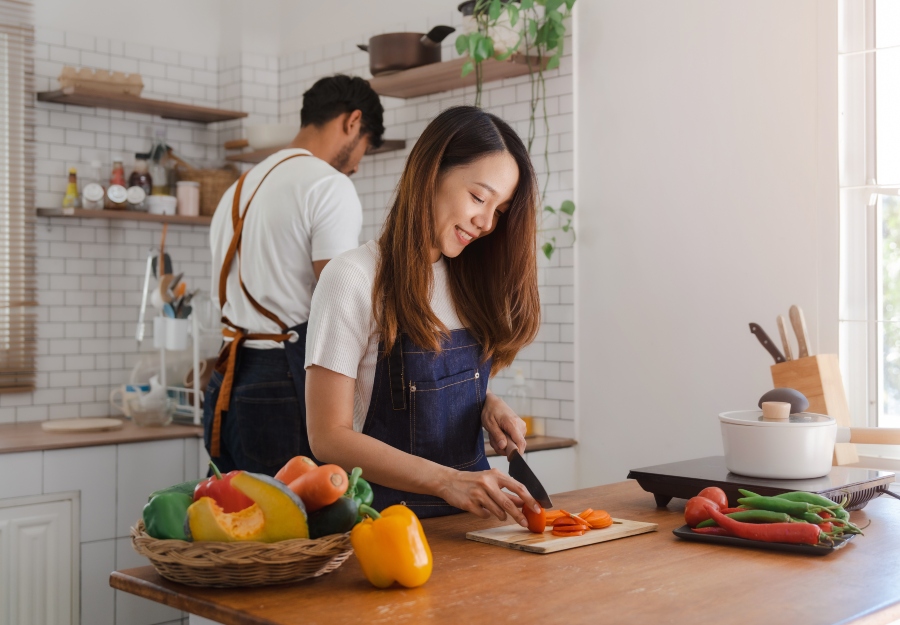 A couple cooking a plant-based meal together