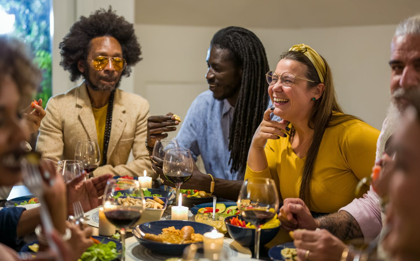 Happy vegans eating around a table celebrating Veganuary