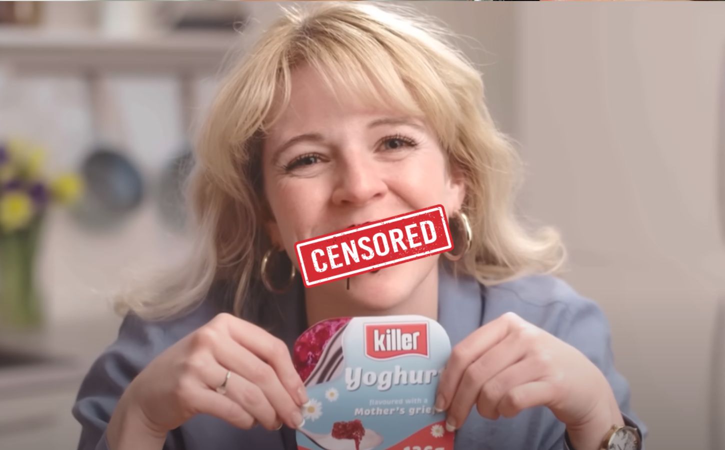 A still from a vegan advert from animal rights organization Viva! showing a woman eating a "killer yogurt" with a "censored" sign over her mouth