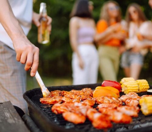 A person cooking meat, which is known to be environmentally damaging, on the BBQ