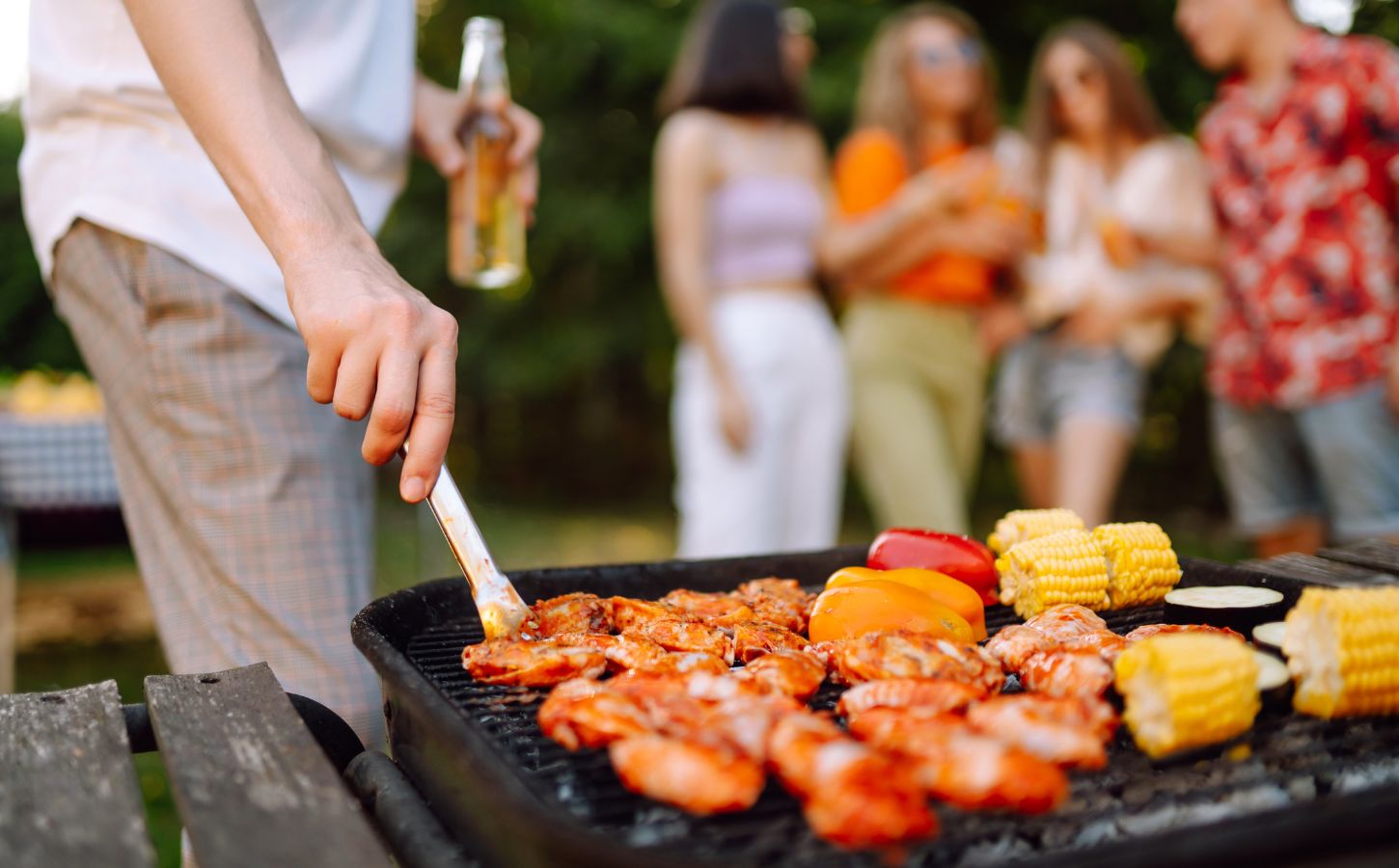 A person cooking meat, which is known to be environmentally damaging, on the BBQ