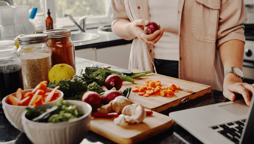 Fruit, vegetables and other plant-based foods laid out on a kitchen counter and chopping block